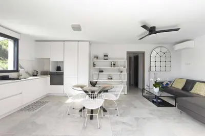 a kitchen and living room with a table and chairs at Apartment 3 rooms with garden in Ajaccio in Ajaccio