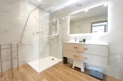 a white bathroom with a sink and a mirror at Apartment 3 rooms with garden in Ajaccio in Ajaccio