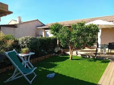 a lawn with a chair and a table in a yard at Villa de luxe en bord de mer Résidence Torra Mare a Prunete in Cervione
