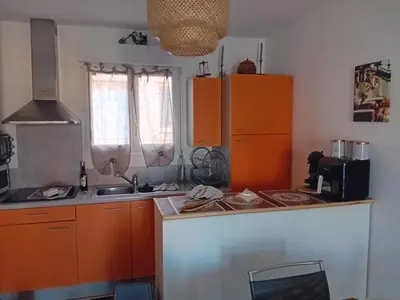 a kitchen with orange cabinets and a counter top at Villa de luxe en bord de mer Résidence Torra Mare a Prunete in Cervione