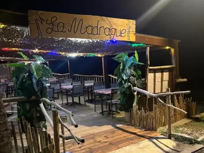 a restaurant with a deck with tables and chairs at Villa de luxe en bord de mer Résidence Torra Mare a Prunete in Cervione