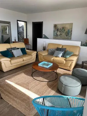 a living room with two couches and a coffee table at Villa Petrera in Valle-di-Campoloro