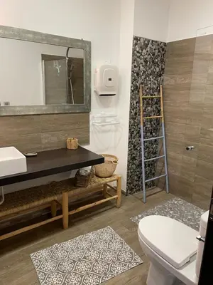 a bathroom with a sink and a toilet and a mirror at Villa Petrera in Valle-di-Campoloro