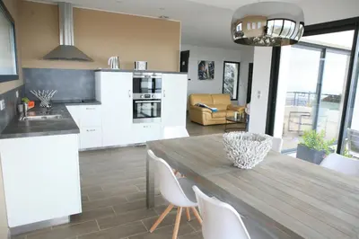 a kitchen and dining room with a wooden table and chairs at Villa Petrera in Valle-di-Campoloro