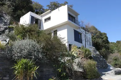 a white house on the side of a mountain at Villa Petrera in Valle-di-Campoloro
