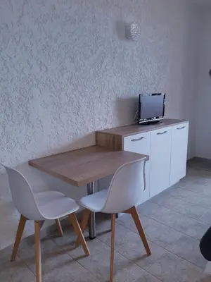 a wooden table with two chairs and a television on it at I Casetti in Molini