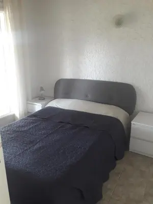 a bedroom with a bed with a blue blanket on it at I Casetti in Molini