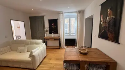 a living room with a white couch and a table at ALG appartement in Corte
