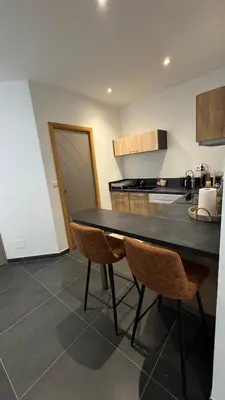 a kitchen with a table and chairs in a room at ALG appartement in Corte