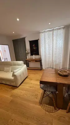a living room with a white couch and a table at ALG appartement in Corte