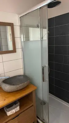 a glass shower in a bathroom with a sink at ALG appartement in Corte