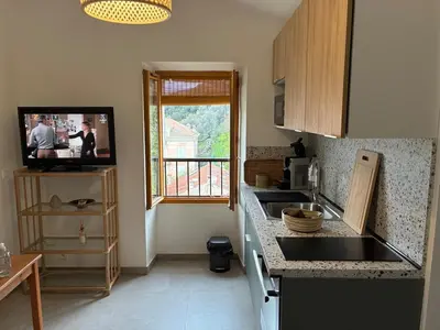 a small kitchen with a sink and a window at Appartement Sainte Lucie de Tallano,2 personnes au centre du village in Santa-Lucia-di-Tallano
