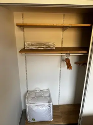 a closet with a white box on a shelf at Bel appartement T3 vue mer 5 min des plages à pied in Propriano