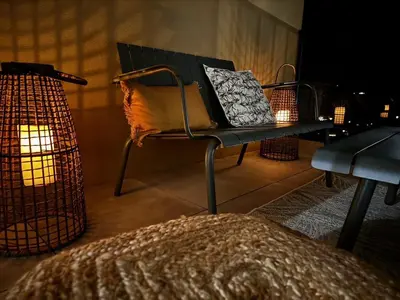 a room with a bench and a table with pillows at Bel appartement T3 vue mer 5 min des plages à pied in Propriano
