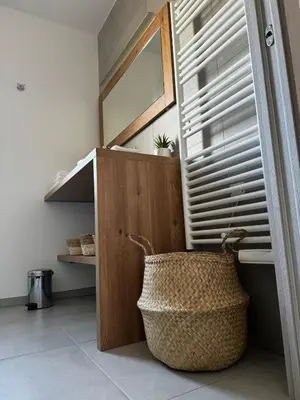 a room with a wooden cabinet and a basket at Bel appartement T3 vue mer 5 min des plages à pied in Propriano