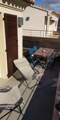 a group of chairs and a table on a patio at un gout de paradis in Zonza