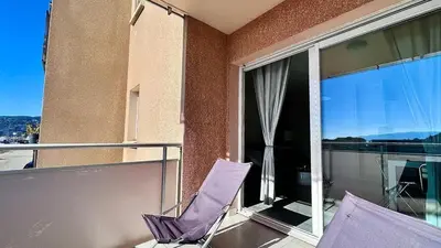 a balcony with a purple chair and a window at Casamea - Vue Mer, Clim & Parking, Proche Plage in Ajaccio