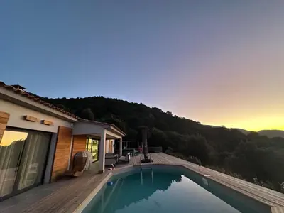 a house with a swimming pool next to a house at Magnifique Villa avec piscine et jacuzzi in Alata