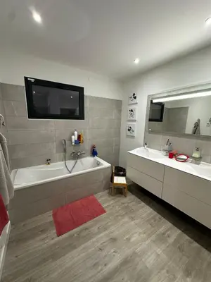 a bathroom with two sinks and a tub and a mirror at Magnifique Villa avec piscine et jacuzzi in Alata