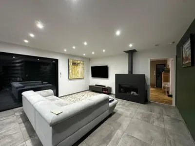 a living room with a couch and a fireplace at Magnifique Villa avec piscine et jacuzzi in Alata
