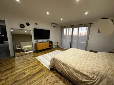 a bedroom with a bed and a large mirror at Magnifique Villa avec piscine et jacuzzi in Alata