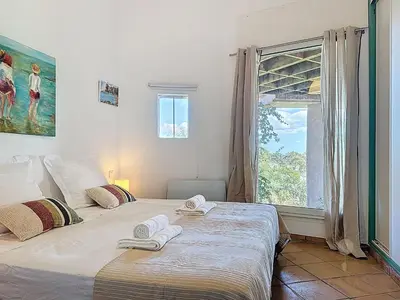 two twin beds in a room with a window at Villa Mimosa 150 m from Pinarello Beach in Zonza