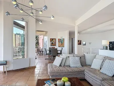 a living room with a couch and a table at Villa Mimosa 150 m from Pinarello Beach in Zonza