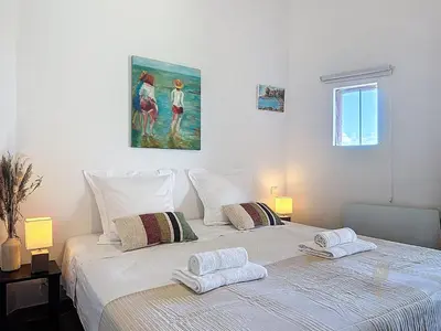 a white bed with two pillows on top of it at Villa Mimosa 150 m from Pinarello Beach in Zonza
