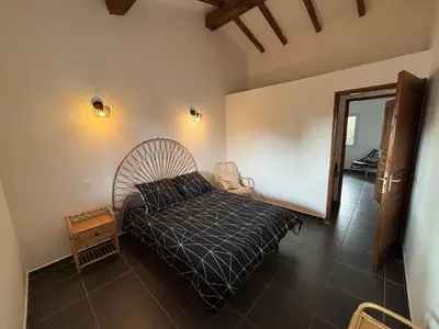 a bedroom with a bed with a black comforter at Casapiana 07 in Porto-Vecchio