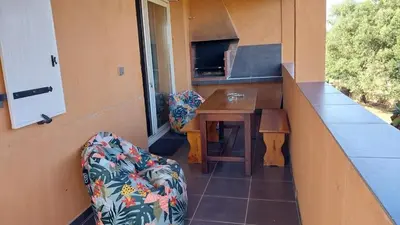 a room with a counter and a table and a chair at Casapiana 07 in Porto-Vecchio