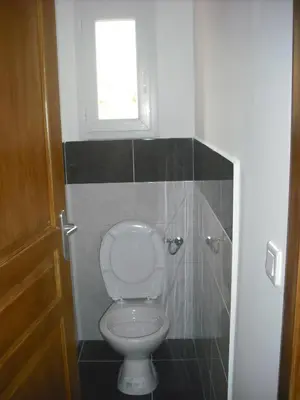 a small bathroom with a toilet and a window at Casapiana 07 in Porto-Vecchio