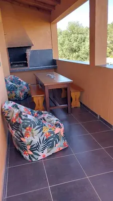 a room with a couch and a table and window at Casapiana 07 in Porto-Vecchio