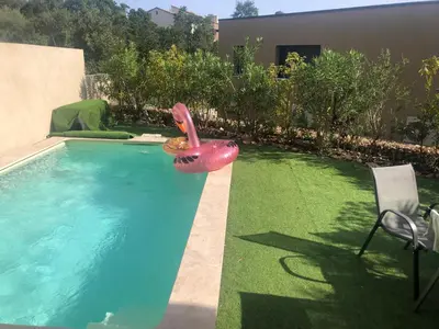 a pool with a inflatable flamingo in the middle of a yard at Villa Favone 3 in Favone