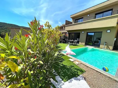 a swimming pool in front of a house at Villa Favone 3 in Favone