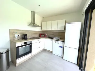 a kitchen with white appliances and white cabinets at Villa Favone 3 in Favone