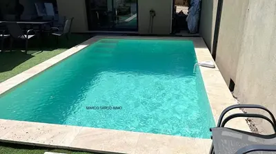 a swimming pool with blue water in a house at Villa Favone 3 in Favone