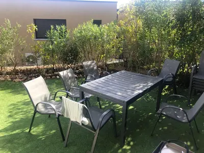 a picnic table and chairs in a yard at Villa Favone 3 in Favone