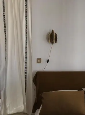 a room with a white curtain and a fan at Casa di a felicita in Bonifacio