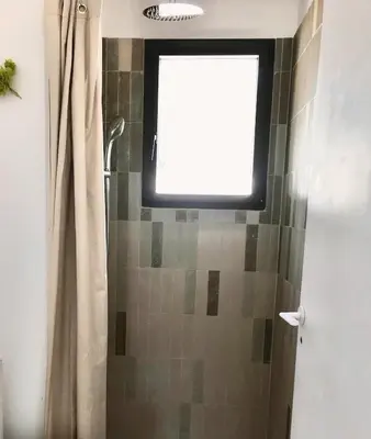a window in a shower with a shower curtain at Casa di a felicita in Bonifacio