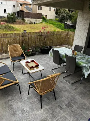 a patio with several chairs and a table and a tableablish at Appart, résidentiel penta-di-Casinca in Penta-di-Casinca