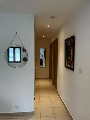 a hallway with a mirror on the wall at Appart, résidentiel penta-di-Casinca in Penta-di-Casinca