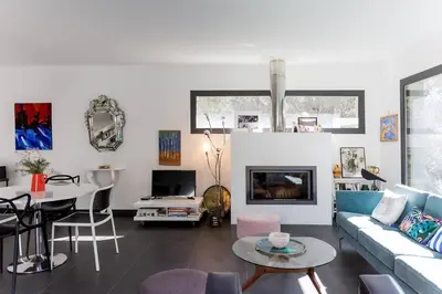 a living room with a couch and a table at Belle villa 3 chambres au cœur du maquis in Porto-Vecchio