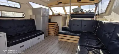 an interior view of an rv with black leather seats at appartement flottant in Ajaccio