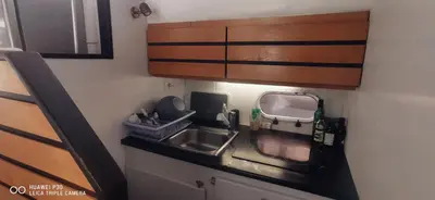 a kitchen counter with a sink and a microwave at appartement flottant in Ajaccio