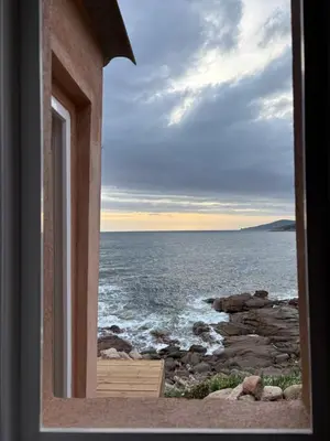 a window view of the ocean from a house at Appartement 2 personnes les pieds dans l'eau in Vico