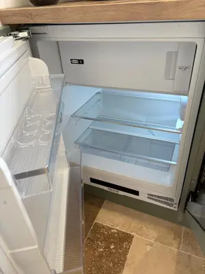 an empty refrigerator with its door open in a kitchen at Appartement 2 personnes les pieds dans l'eau in Vico