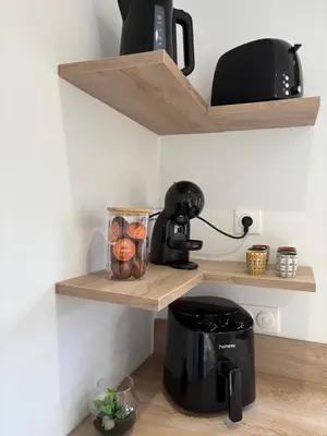a coffee maker on a shelf in a kitchen at Appartement 2 personnes les pieds dans l'eau in Vico