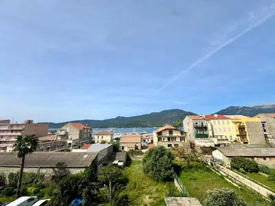 a view of a city with buildings and the ocean at Studio cosy au cœur de Propriano in Propriano