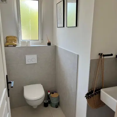 a bathroom with a toilet and a sink and a window at Villa Fiori Porto Vecchio avec piscine privée in Porto-Vecchio