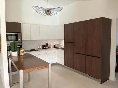 a kitchen with a table and a butterfly on the ceiling at Villa Fiori Porto Vecchio avec piscine privée in Porto-Vecchio